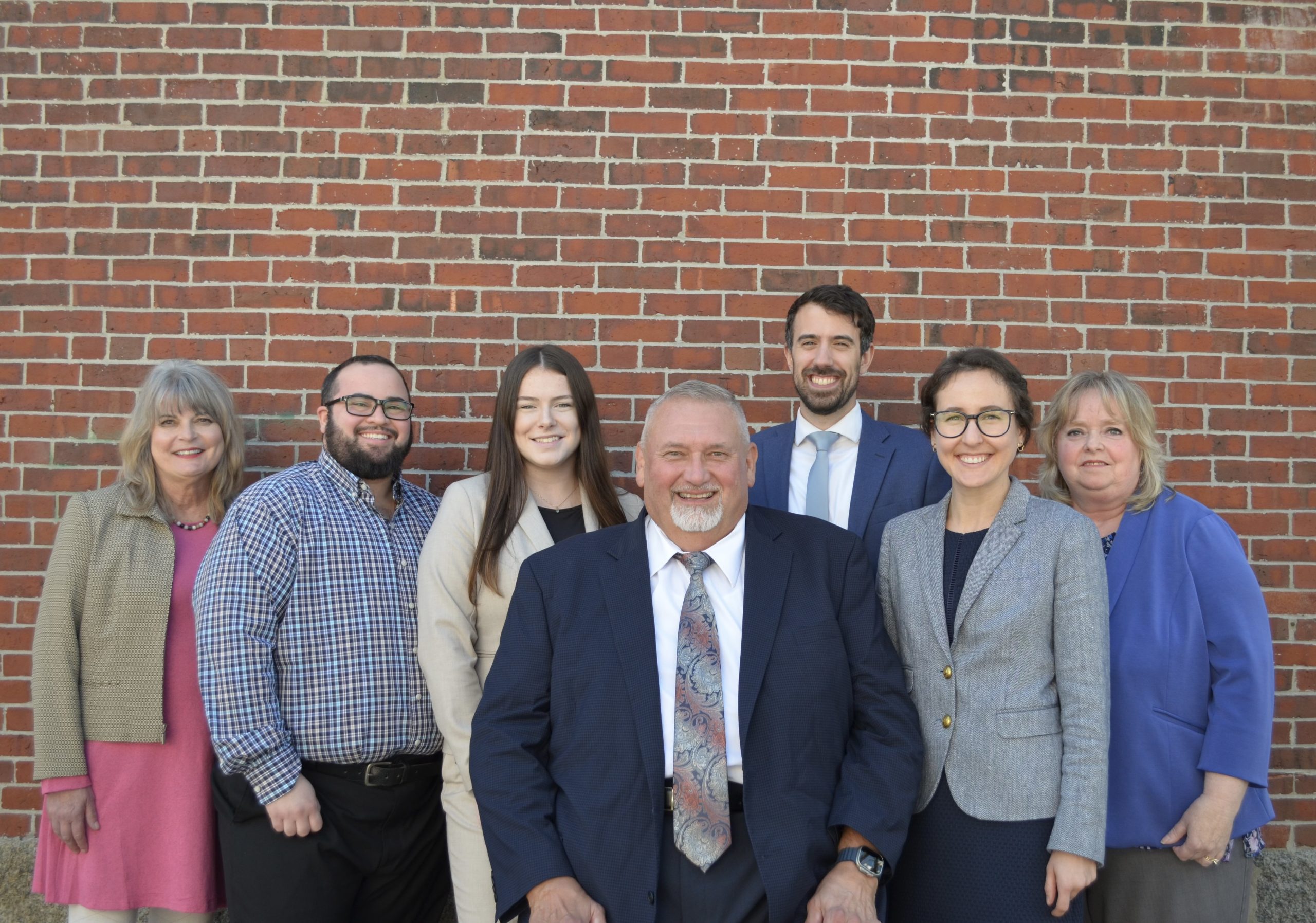 Webb Law Firm team of attorneys and staff posing together at office